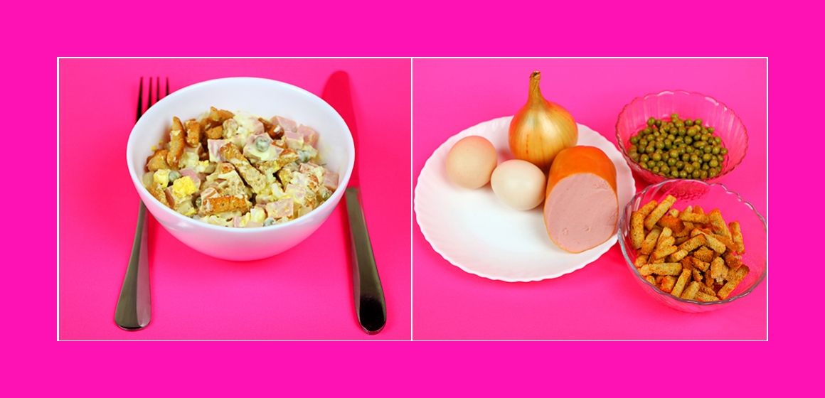 Leckerer Salat mit Kochwurst, Croutons, Eiern und grünen Erbsen